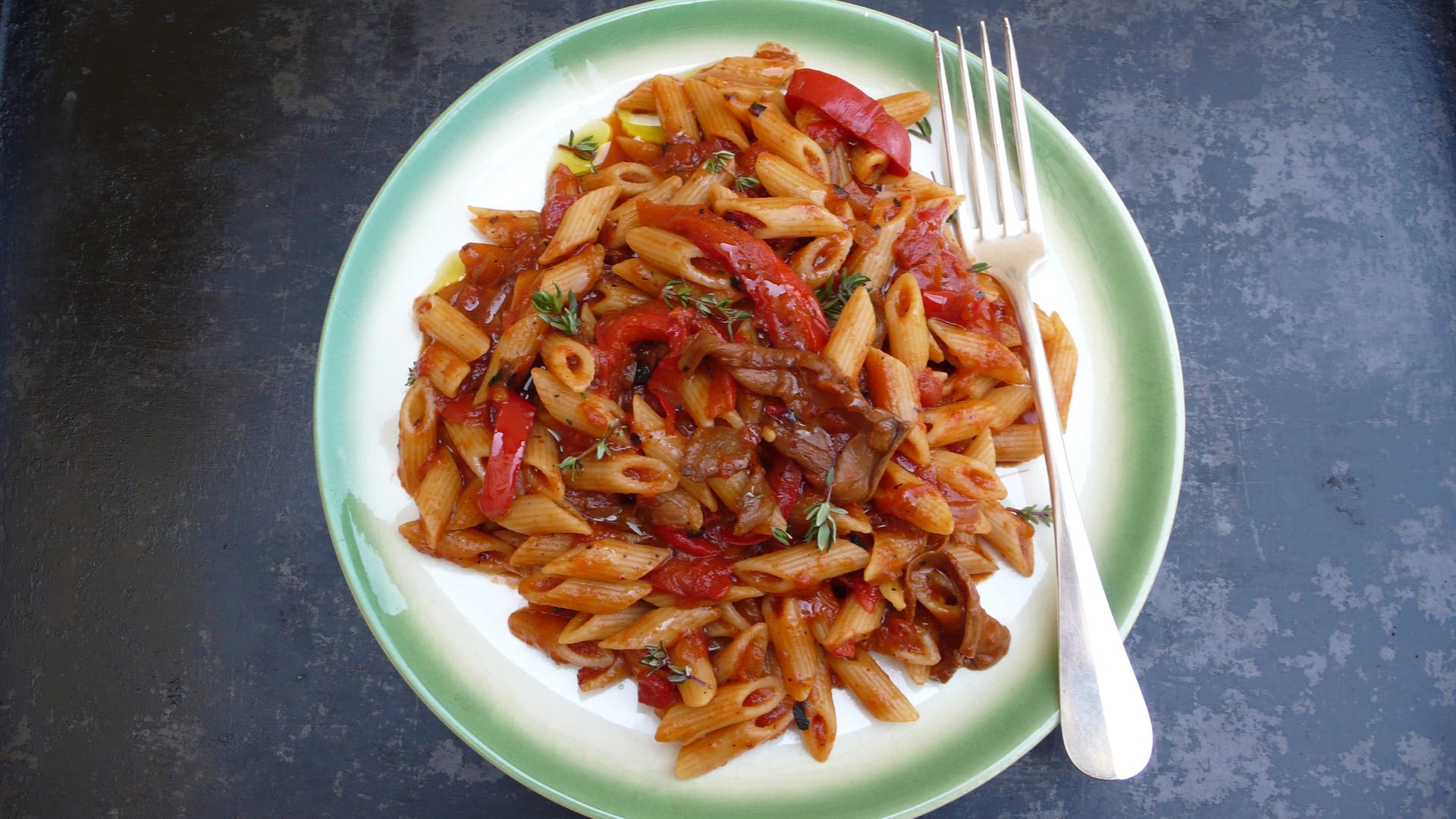 a delicious plate of pasta with porcini and sweet peppers in tomato sauce