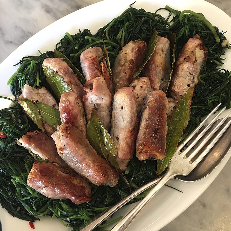 thin slices of pork rolled with pancetta and baked served on a bed of agretti